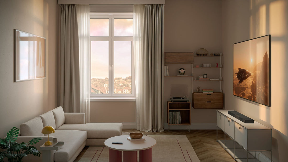 Modern living room with a large window, sofa, sideboard, TV & on the sidebaord there is a XIO soundbar placed on top of it.