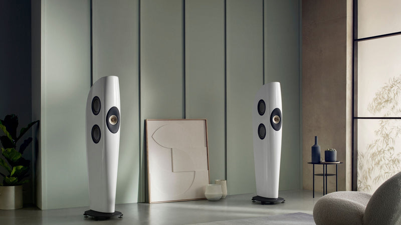 A white pair of KEF Blade Two Meta HiFi Luxury speakers displayed in a stylish interior space.